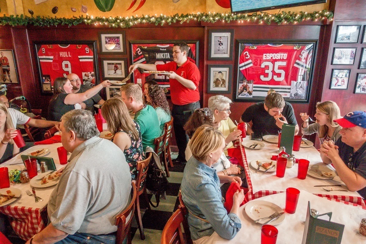 Tour group being served pizza