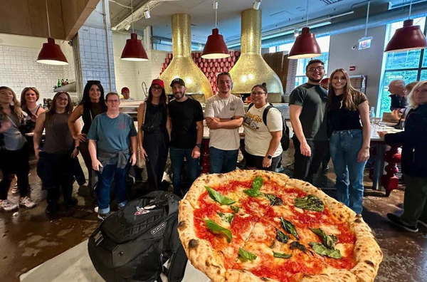 Pizza tour group enjoying slices